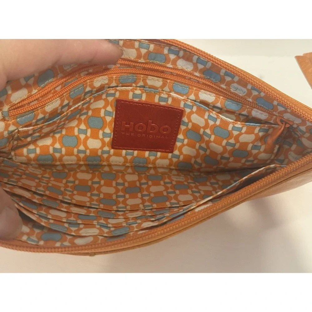 HOBO The Original Orange Leather Wristlet Clutch Bag Geometric Lining Grommet